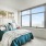 bed near large window with city view