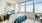 bed near large window with city view