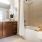 bath tub near counter and mirror