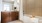 bath tub near counter and mirror
