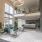 large room with plants and seating area