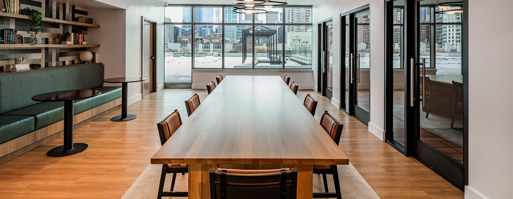 bright room with long conference table surrounded by chairs