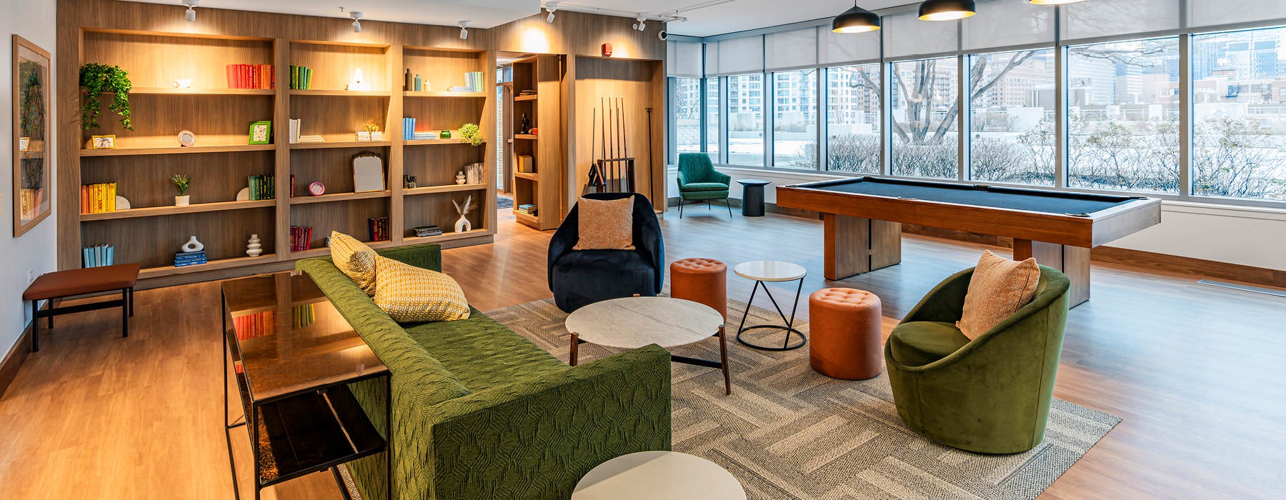clubhouse with large bookshelves and pool table